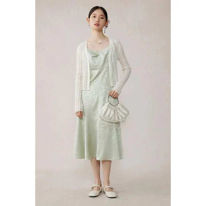 Elegant mint green midi dress with spaghetti straps, featuring a flattering slim fit and beautiful embroidery detailing