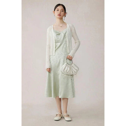 Elegant mint green midi dress with spaghetti straps, featuring a flattering slim fit and beautiful embroidery detailing
