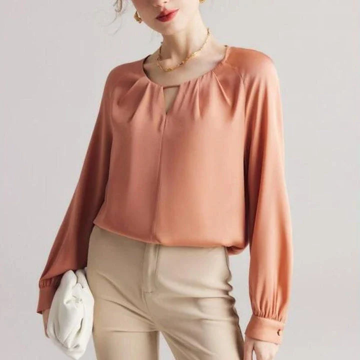 Elegant silk-blend blouse with raglan sleeves, featuring a timeless design and unique hollow-out details