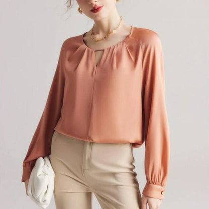 Elegant silk-blend blouse with raglan sleeves, featuring a timeless design and unique hollow-out details