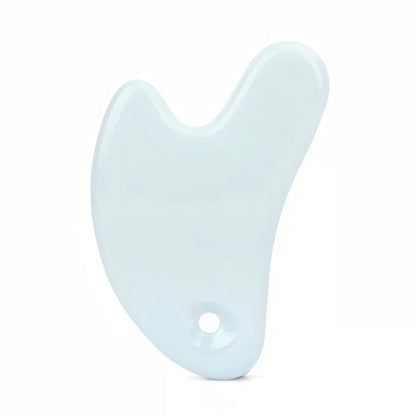 Ceramic Gua Sha facial massager in blue, pink, and white colours, designed to improve circulation and promote lymphatic drainage for radiant, youthful skin.