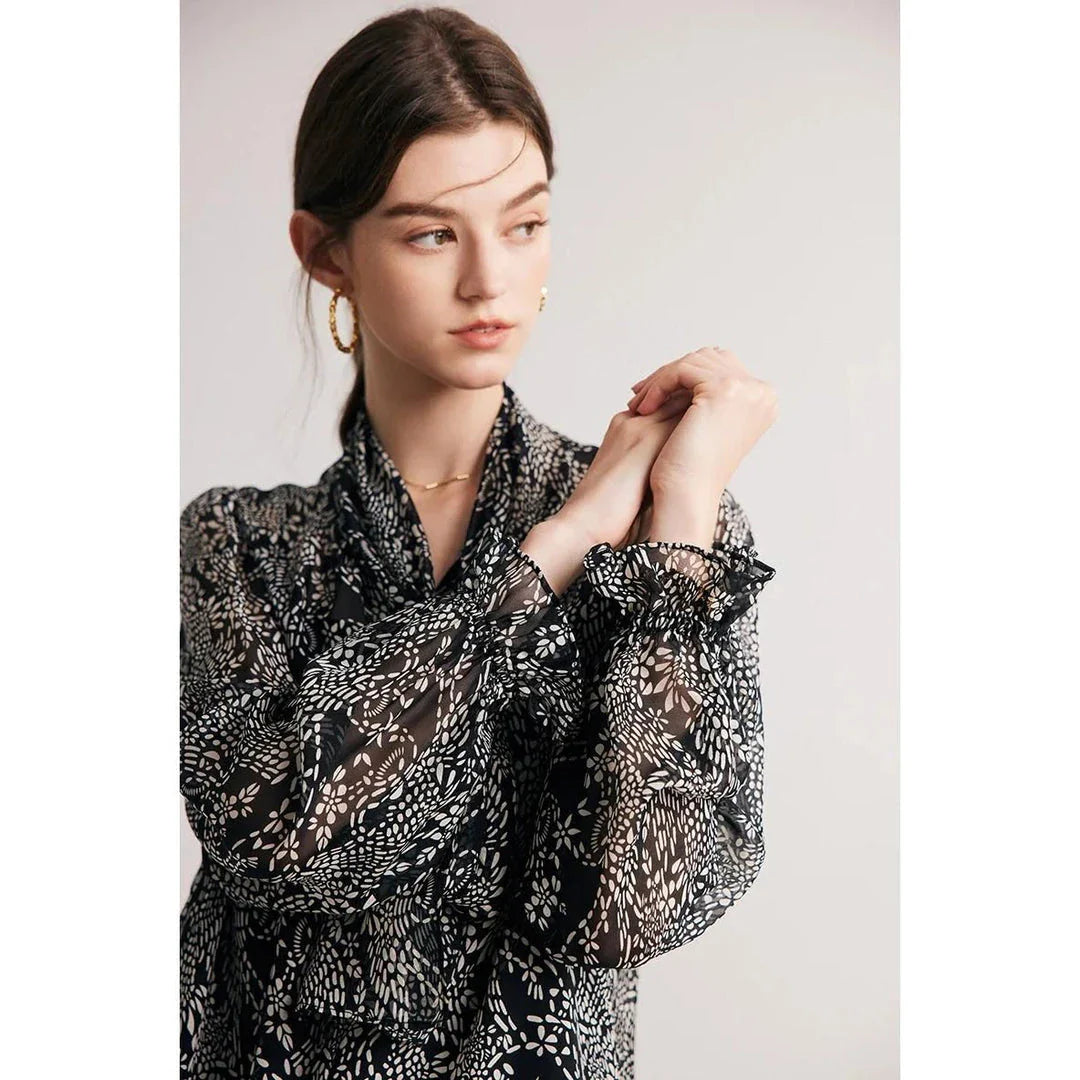 Elegant black silk blouse with unique bow collar, designed for a flattering fit and all-day comfort.