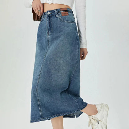 Classic blue A-line midi denim skirt with flattering empire waistline and flowy silhouette