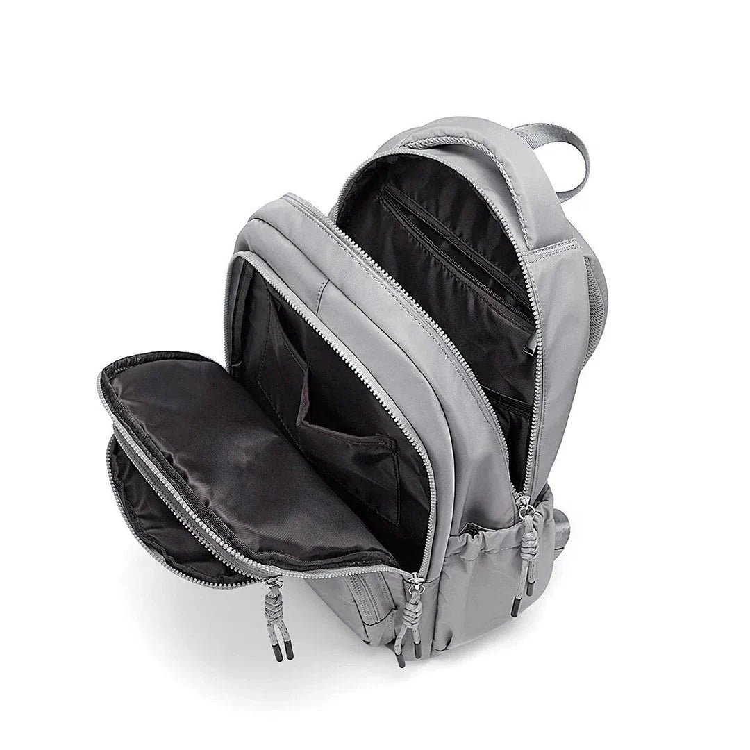 Premium leather backpack with dedicated laptop compartment, soft handles, and arcuate shoulder straps for modern women