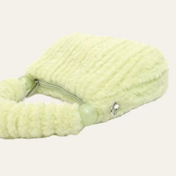 A luxurious faux fur hobo handbag with a stylish baguette shape and secure zipper closure