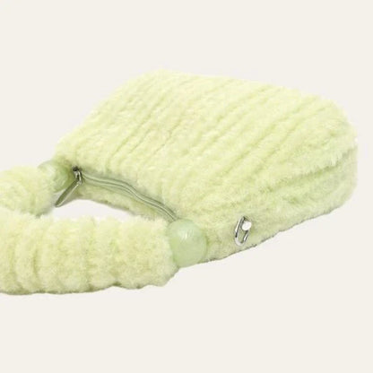 A luxurious faux fur hobo handbag with a stylish baguette shape and secure zipper closure