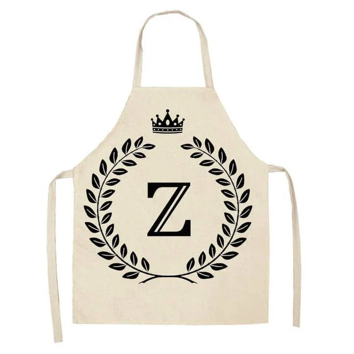 A high-quality kitchen apron featuring a charming crown and letter print design in a premium cotton and linen blend fabric.