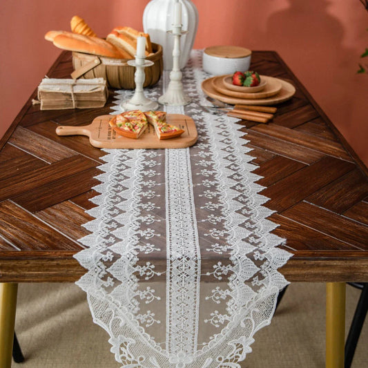 Elegant lace table runner with intricate embroidery and hollowed-out patterns, adding sophistication to any dining setting