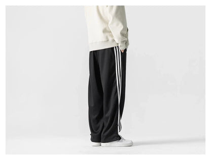 Stylish striped sports trousers in a relaxed, mid-waist design for versatile leisure and athletic wear