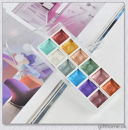 A set of vibrant watercolour paints with a glittering, iridescent effect, including brushes, a palette, and paper for a complete painting experience.