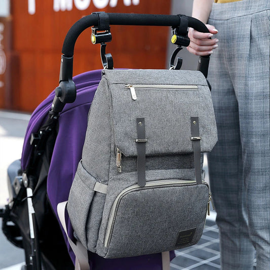 A stylish and practical mummy backpack with multiple pockets, perfect for organising and transporting all your parenting essentials.