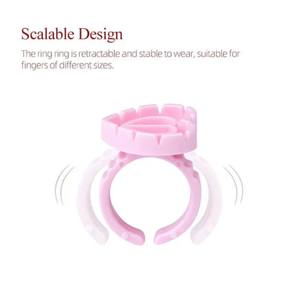 Heart-shaped disposable eyelash glue rings in blue, pink, and white colours