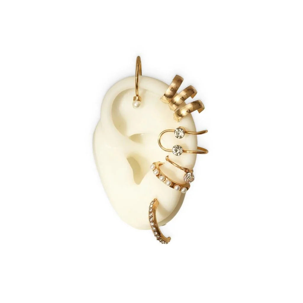 A set of 8 sophisticated gold-toned pearl stud earrings with unique, eye-catching designs