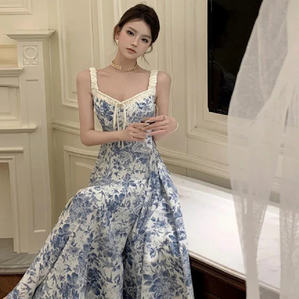 Elegant floral print dress with adjustable straps, A-line silhouette, and high-waisted design for a timeless British fashion look.
