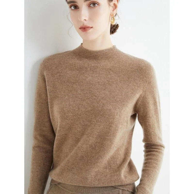 A woman wearing a luxurious Merino wool mock-neck jumper in a stylish autumnal outfit