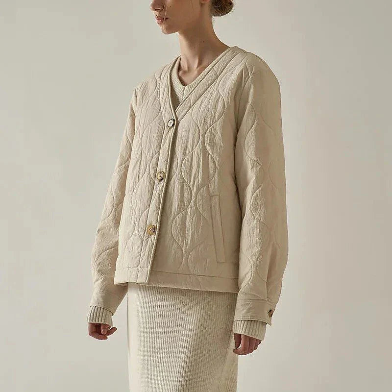 Women's black quilted jacket with button details, perfect for casual winter wear