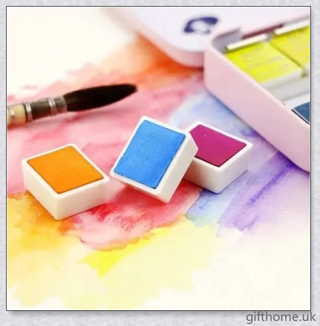 A set of vibrant watercolour paints with a glittering, iridescent effect, including brushes, a palette, and paper for a complete painting experience.