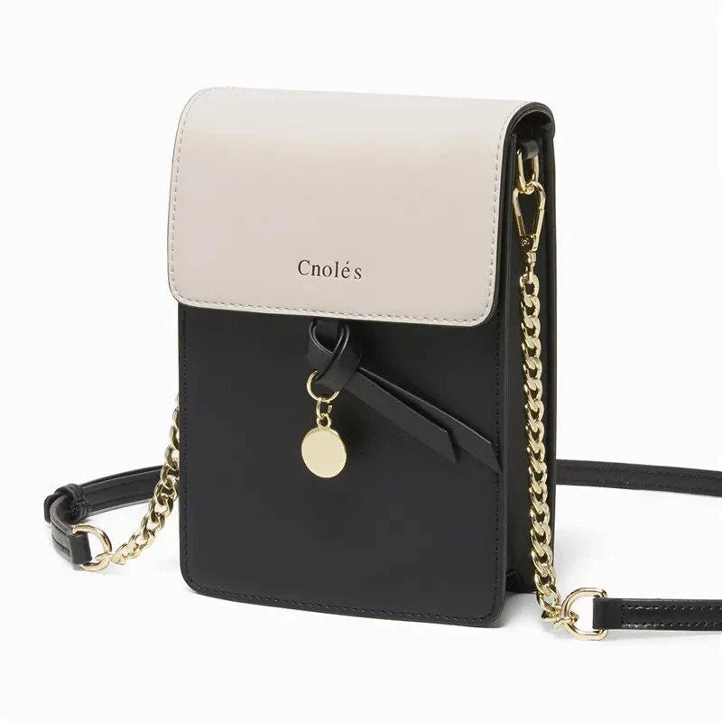 Stylish black leather crossbody phone bag with tassel accent, offering secure storage and versatile design for everyday use.