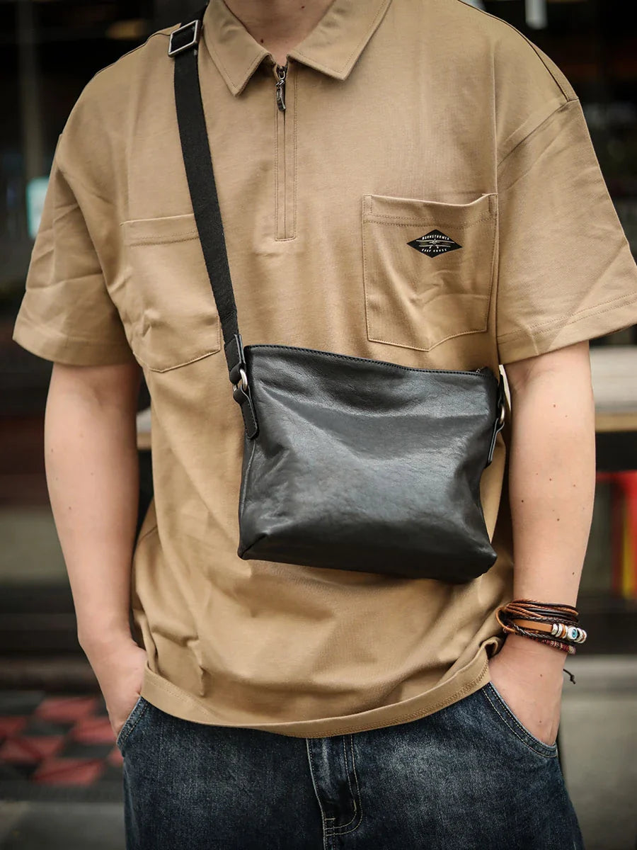 Premium black leather shoulder bag with horizontal zipper closure, featuring a spacious interior and versatile design for the modern British gentleman