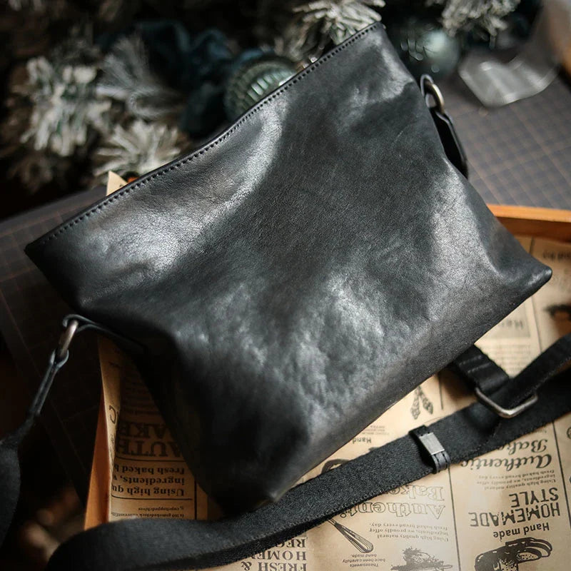 Premium black leather shoulder bag with horizontal zipper closure, featuring a spacious interior and versatile design for the modern British gentleman