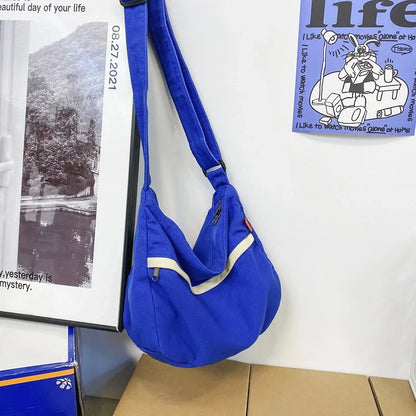 A stylish and durable canvas tote bag with a spacious interior and a timeless vintage-inspired design, perfect for everyday use and travel