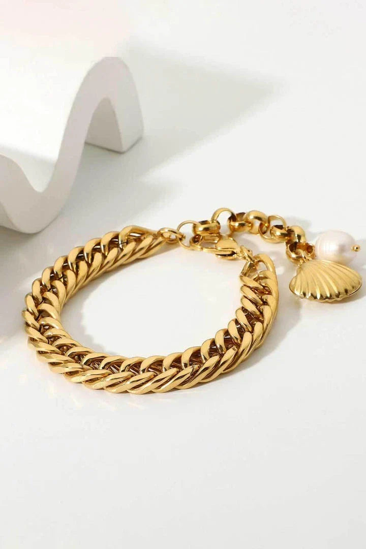 Elegant 18-carat gold-plated curb chain bracelet with a delicate pearl accent, showcasing premium British craftsmanship