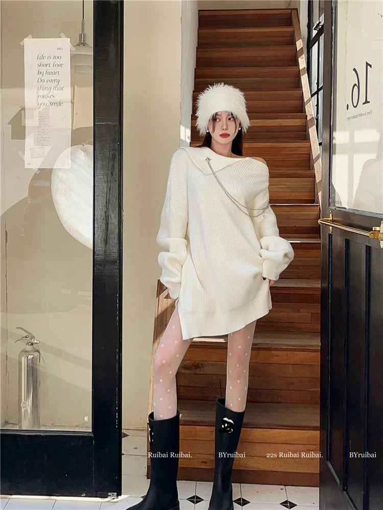 Luxurious off-the-shoulder zipper sweater in black and beige, featuring lantern sleeves and a cozy alpaca wool blend