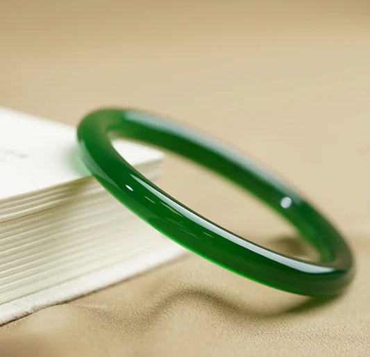 Stylish agate chalcedony bracelet with jingle bell charm in classic green hues
