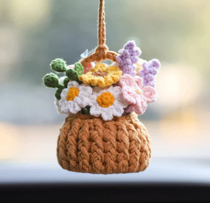 Charming knitted car plant decor with hanging white rope and green and white colour scheme