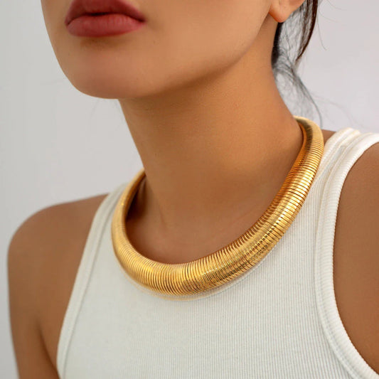 Captivating spiral chunky choker necklace in gold and silver colours, featuring a bold, geometric design for a unique, statement-making look.