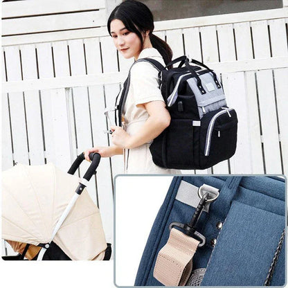 Multifunctional maternity diaper backpack with removable mosquito net, foldable crib, and water-resistant design for convenient family travel