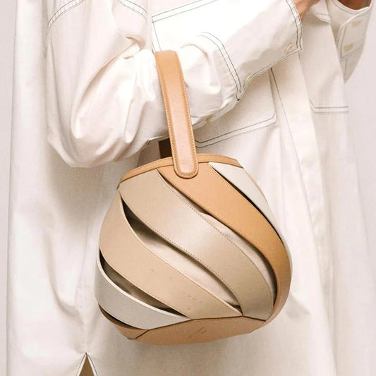Stylish striped PU leather bucket handbag with versatile carry options and roomy interior