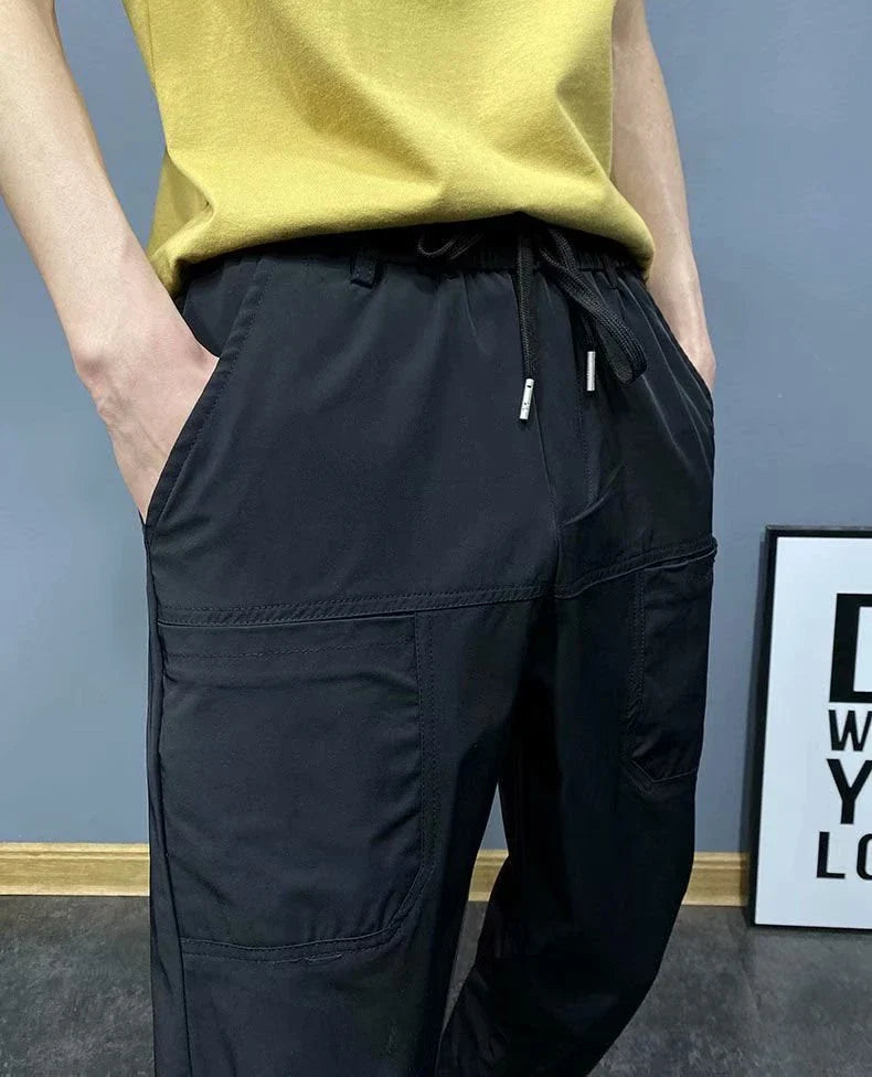 Premium slim-fit drawstring joggers in black and grey, featuring a tailored silhouette and adjustable waistband for a polished, comfortable look.