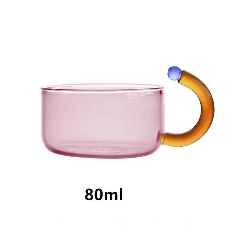 Elegant colourful glass teapot and teacup set with vibrant contrasting colours, perfect for tea and coffee enjoyment