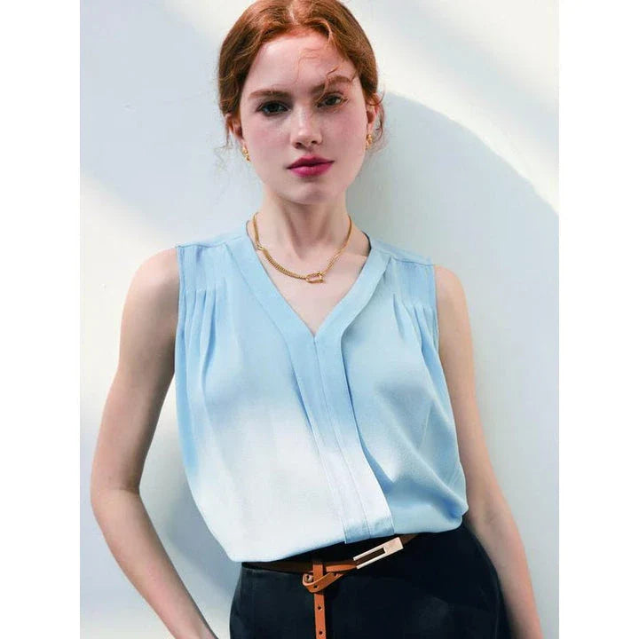 Elegant sleeveless silk blouse in a vibrant blue colour, designed for a sophisticated summer style