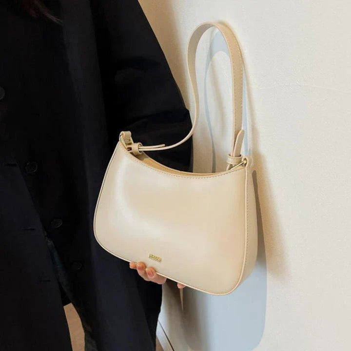 Luxury red leather crossbody bag with sleek design and elegant details