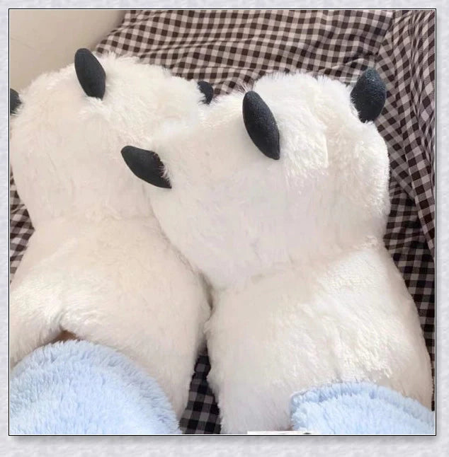 Cosy and whimsical oversized bear paw winter slippers with a plush, fluffy design and non-slip sole for secure indoor wear