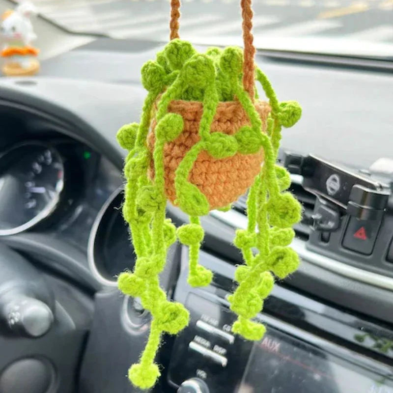 Charming knitted car plant decor with hanging white rope and green and white colour scheme