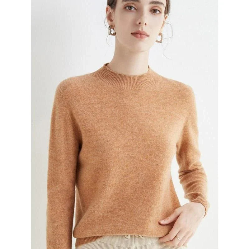 A woman wearing a luxurious Merino wool mock-neck jumper in a stylish autumnal outfit