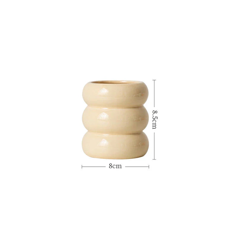 A white ceramic candlestick holder with a minimalist Nordic design, perfect for creating a cosy and sophisticated ambience in any room.