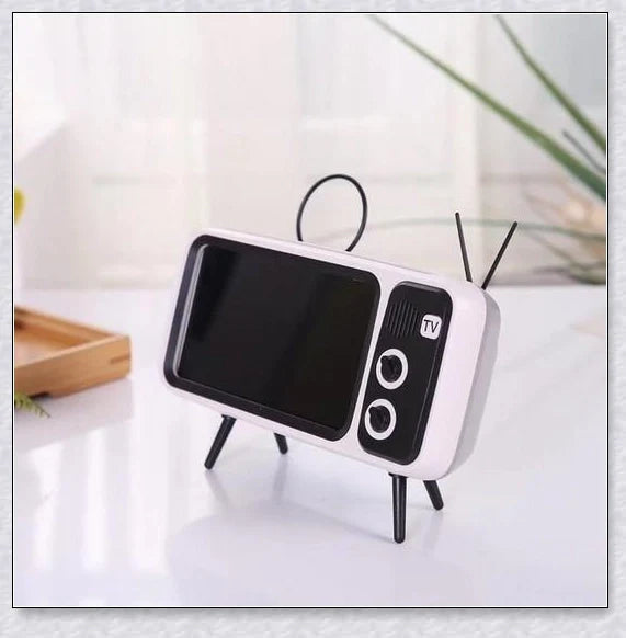 Retro TV-inspired phone stand with built-in Bluetooth speaker for hands-free entertainment and music playback