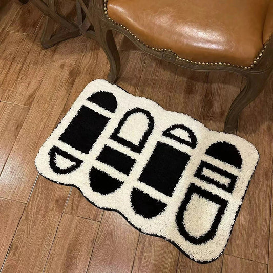Tufted black and white geometric area rug with a soft, plush texture and anti-slip backing