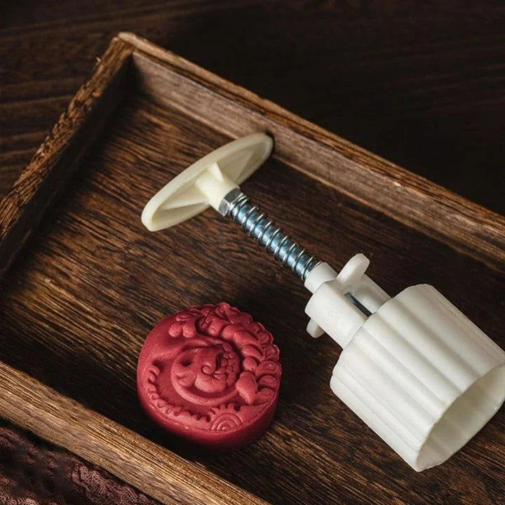 A hand-pressed chocolate stamping tool made of durable plastic, designed to add a personal touch to homemade chocolates, cakes, and baked goods.