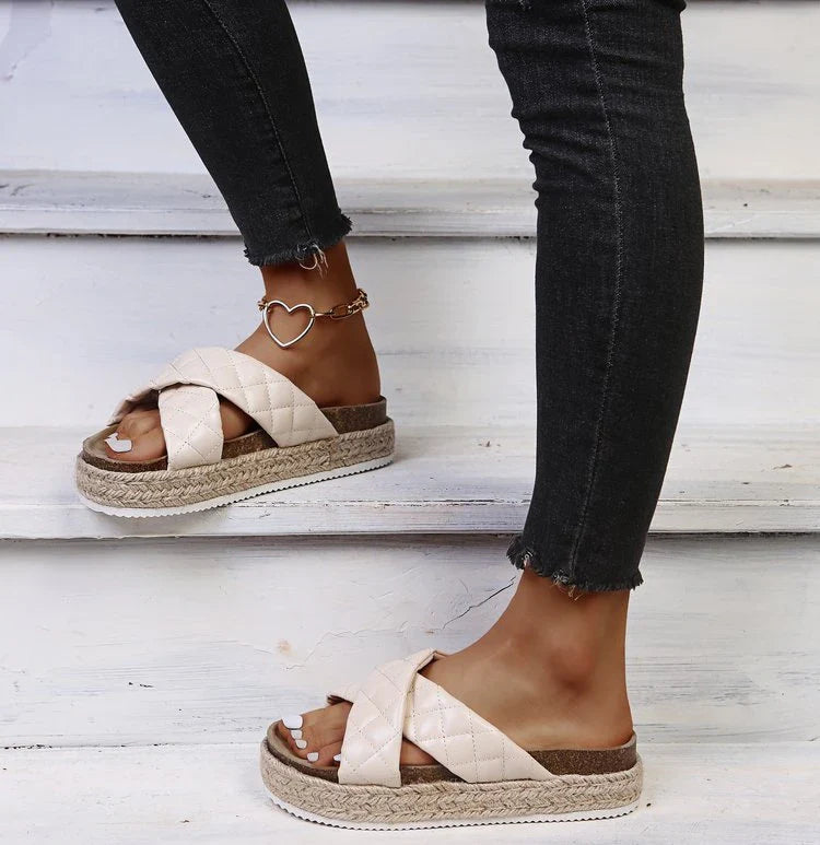 Elegant cross-toe platform sandals and slippers in a neutral creamy white hue, showcasing a contemporary and refined design for the discerning woman