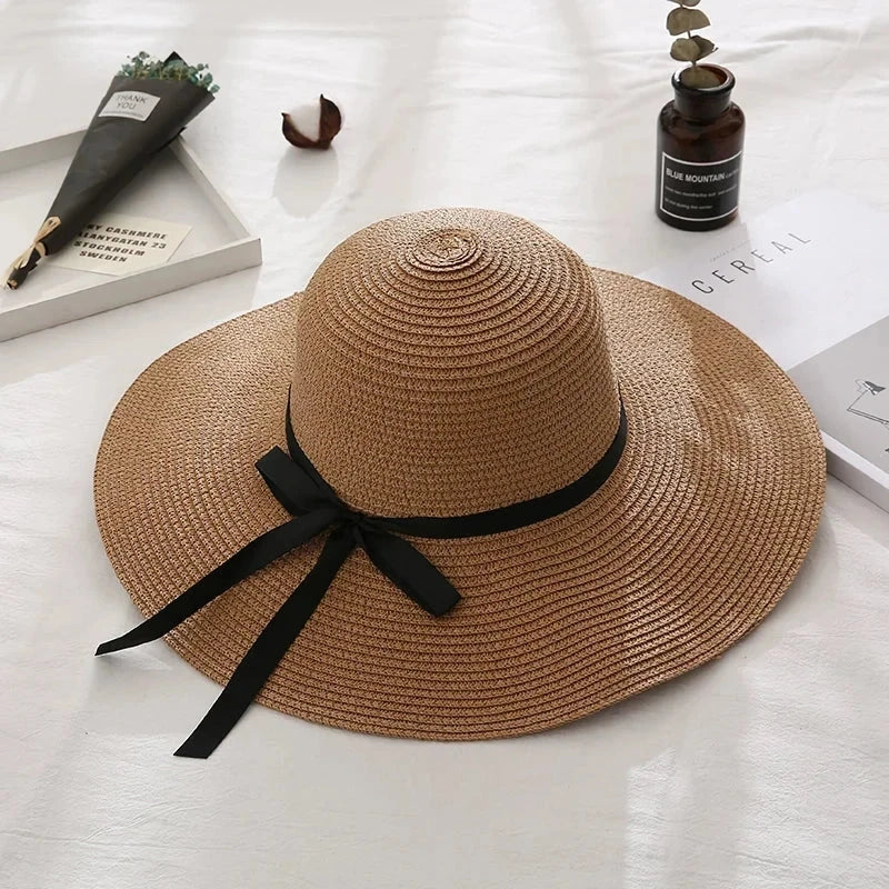 Fashionable straw hat for women with wide brim, foldable design, and stylish bow detail