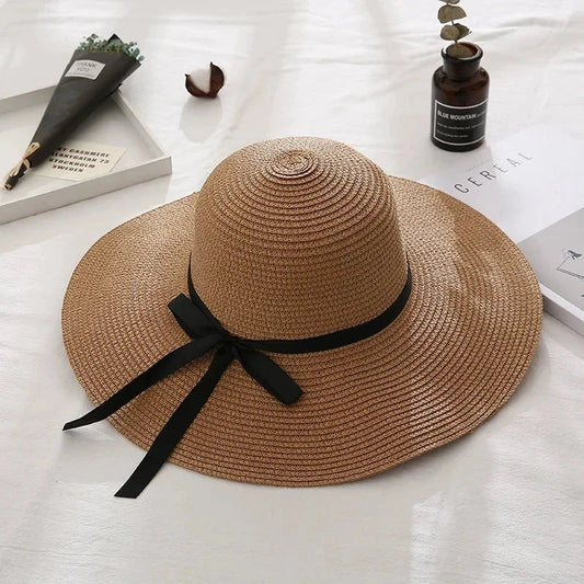 Fashionable straw hat for women with wide brim, foldable design, and stylish bow detail
