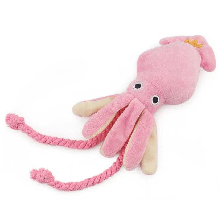 A soft, plush pink squid-shaped dog toy with a vibrant and whimsical design