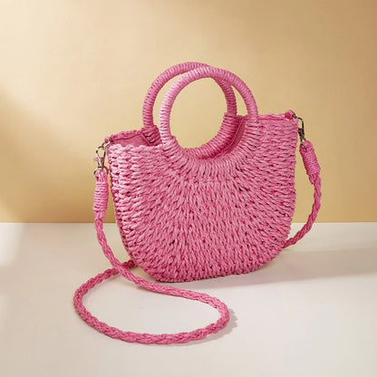 Stylish straw woven women's beach shoulder bag in a half-moon shape, featuring a cotton lining and string closure for a minimalist, bohemian-inspired look.