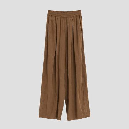 Pleated wide-leg high-waisted trousers in a herringbone plaid pattern, featuring a flattering silhouette and comfortable cotton-linen blend