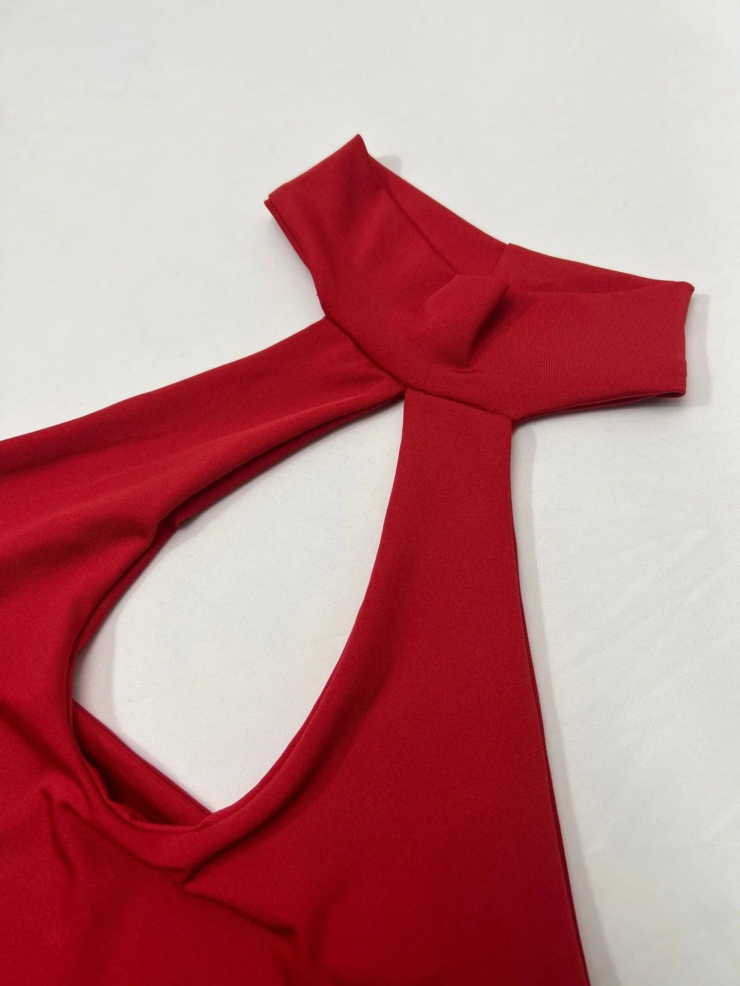 A chic backless halter dress made from premium milk silk with cut-outs at the hips, perfect for formal or semi-formal events.